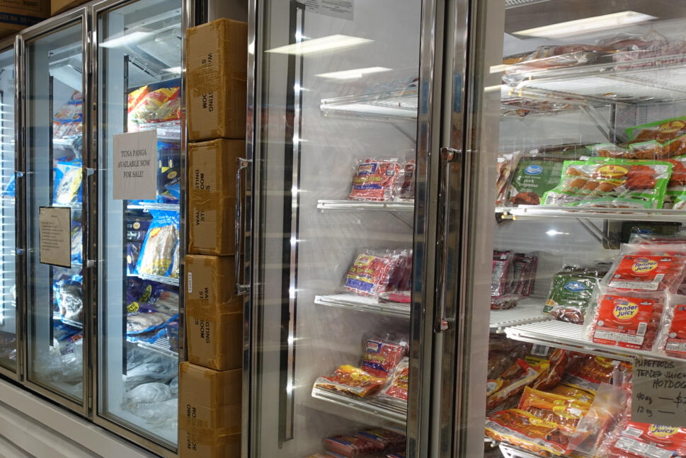 Asian grocery frozen section with frozen meats, ready-to-eat meals, and snacks.